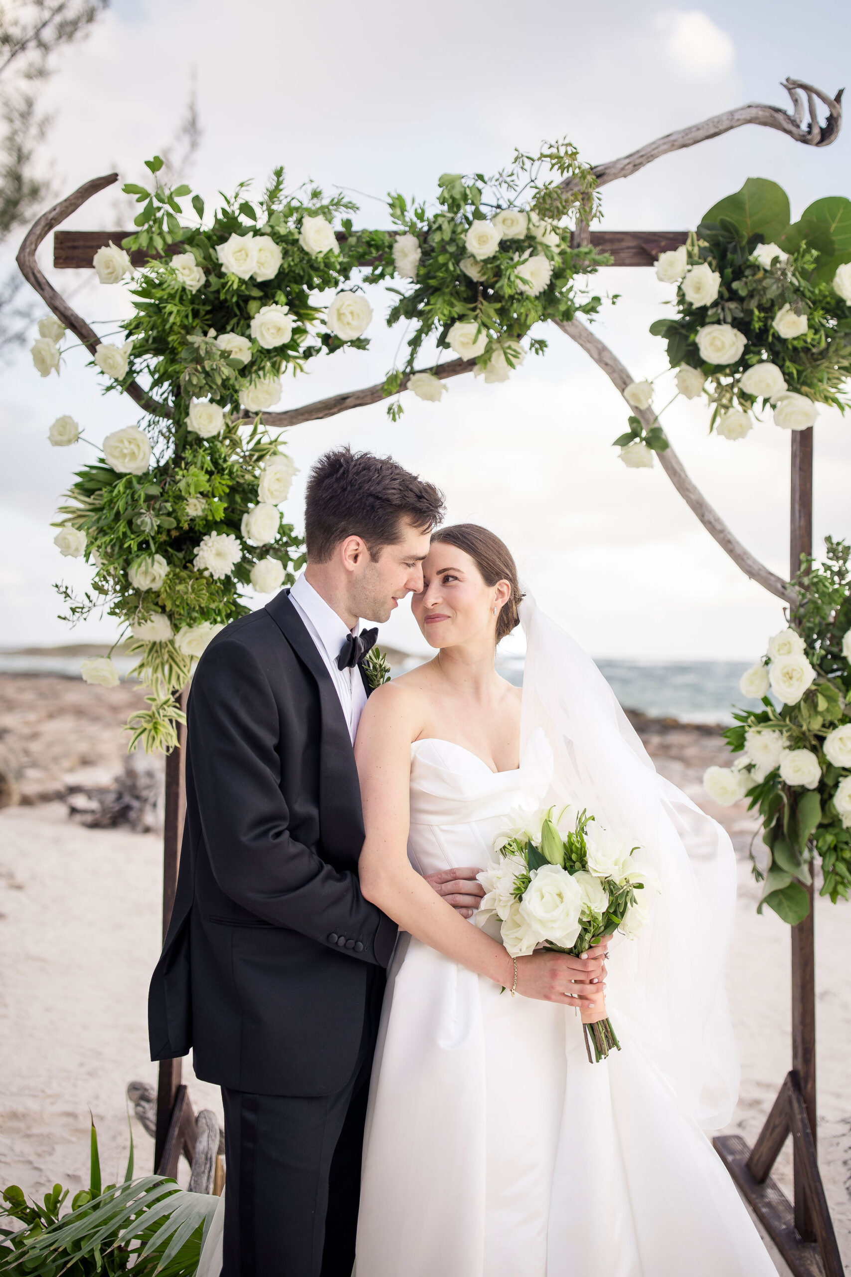 A picture of a bride and groom with flowers on their wedding day