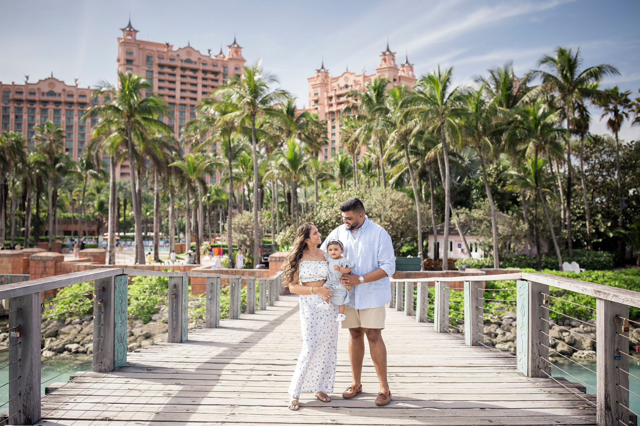 a family of 3 on a bridge at the atlantis
